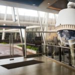 Video surveillance camera near an office entrance.