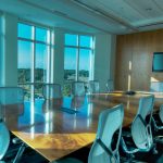 Image is of a conference room table and chairs in a commercial office.