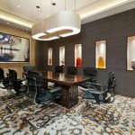 Spacious room with a large table, chairs, and conference room technology for smooth collaboration.