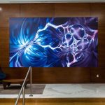 An immersive video wall displaying blue and violet abstract designs.